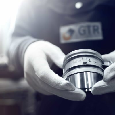 Employee of the foundry shows casting of GTR from die casting